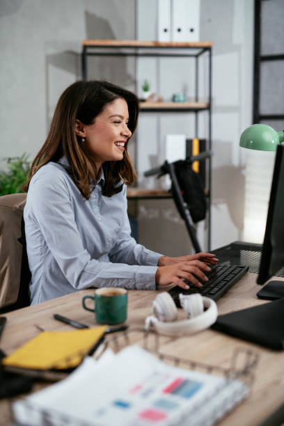 istock Beautiful young woman working on computer at her workplace 1295229069