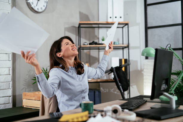 istock Happy businesswoman in office. 1295230211