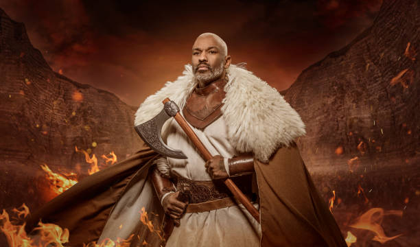istock Weapon wielding viking inspired black african warrior in a fantasy fire setting 1295232899