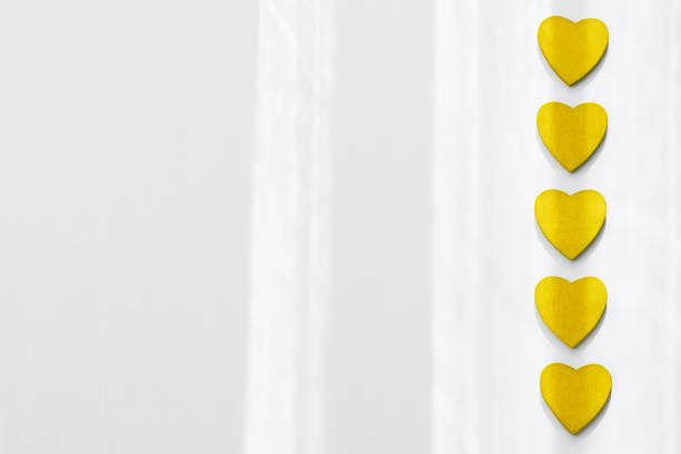 istock Trendy yellow heart on grey background 1295233582