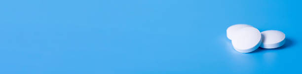 istock three anti-inflammatory pills on blue background for a healthy lifestyle. 1295242533