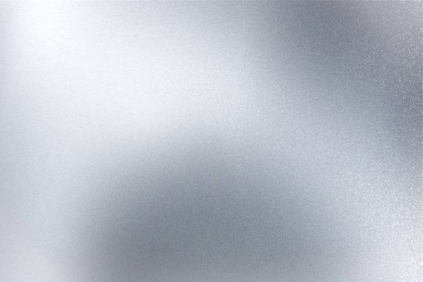 istock Light shining on gray silver foil glitter metallic wall with copy space, abstract texture background 1295244065
