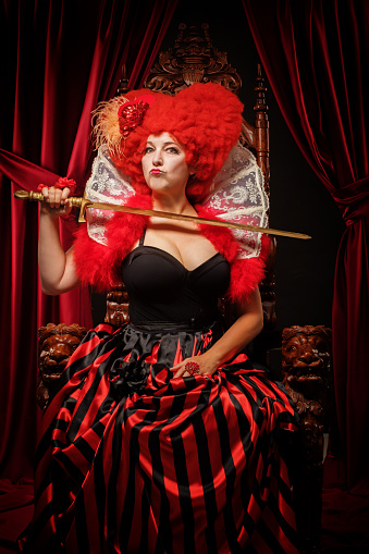 Queen of Hearts like female character in a studio shot