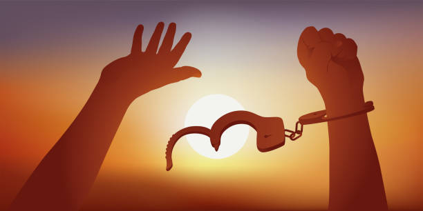 Symbol of freedom with the handles of a prisoner without his handcuffs before a sunset. Concept of human rights with two raised hands that are freed from their handcuffs, in front of the symbol of a setting sun. european court of human rights stock illustrations