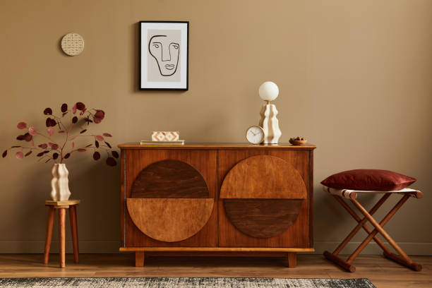 Stylish interior with design wooden commode, stool, dried flowers in vase, unique decoration, carpet, mock up poster frame and elegant personal accessories. Modern living room in classic house. Stylish interior with design wooden commode, mock up poster frame and elegant personal accessories. Modern living room in classic house. art deco vase stock pictures, royalty-free photos & images