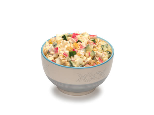 istock Salad with corn, crab sticks, cucumbers, eggs and mayonnaise in a bowl 1295251294