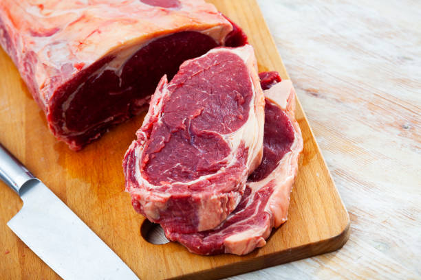 istock Raw beef meat with sliced pieces on wooden surface 1295253145
