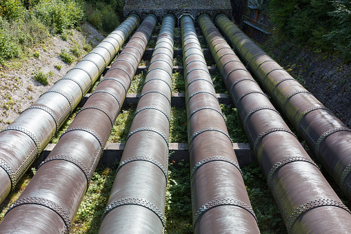 Kochelsee, Germany - Oct 1, 2020: Water pipes at the Walchensee hydroelectric power plant. Symbol for emission free power generation.