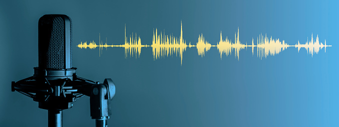 Studio microphone on blue background with yellow waveform, Podcast or recording studio banner with copy space