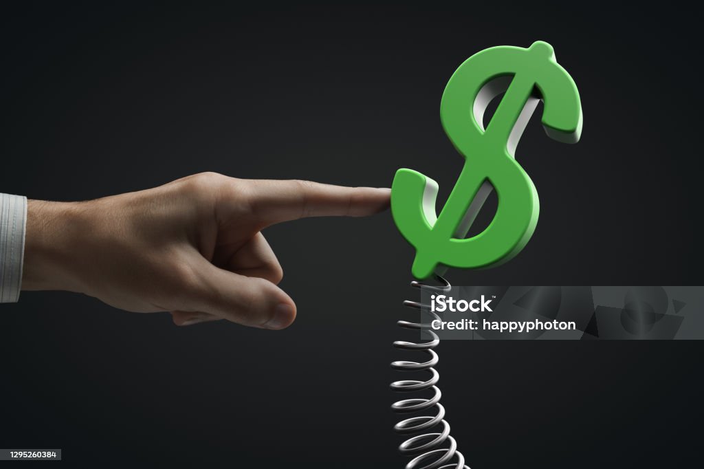 Pressure on the American currency concept. Hand influences Dollar symbol on a spring. Pressure on the American currency concept. Hand influences Dollar symbol on a spring Flexibility Stock Photo