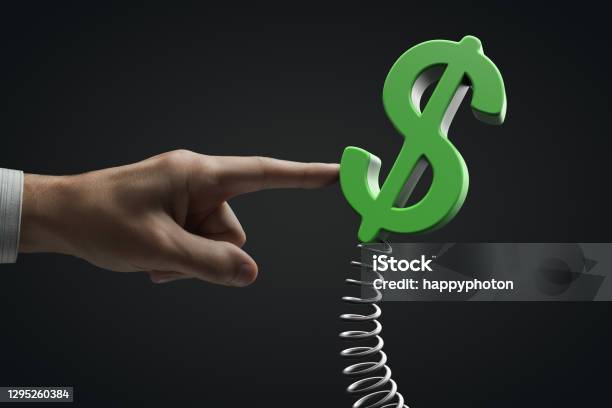Pressure On The American Currency Concept Hand Influences Dollar Symbol On A Spring Stock Photo - Download Image Now