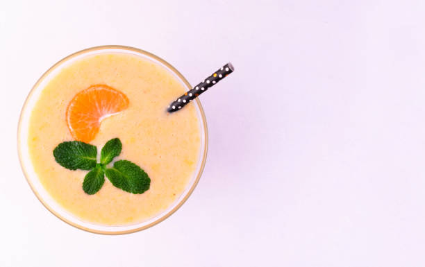 istock Tangerine smoothie with mint on a white background. Flat lei.Copy space. 1295261085