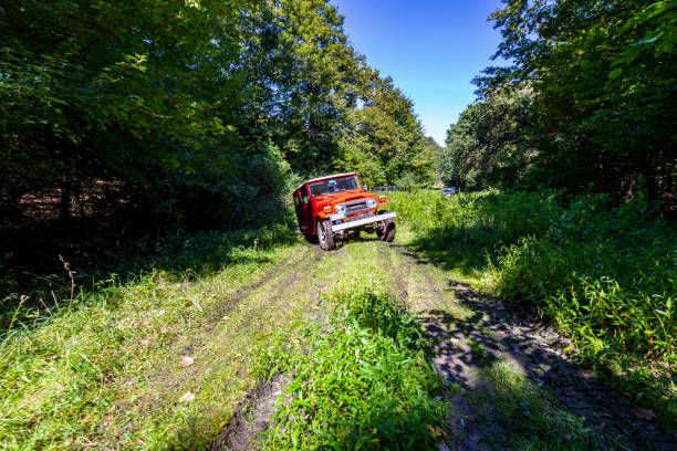 An offroad jeep in motion blurred on a road, Sports utility vehicle for adventure
