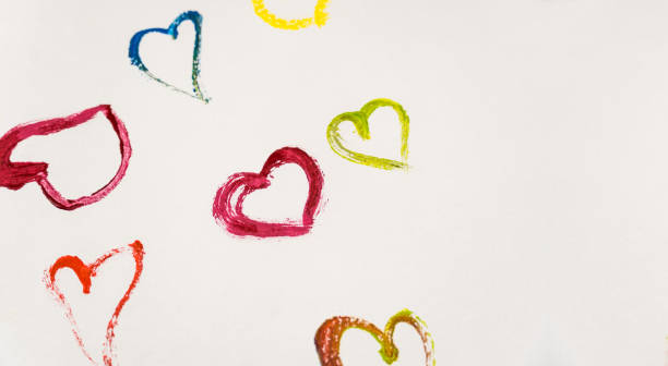 istock Multicolored hearts on a white background with copy space. The hearts are painted with multi-colored paints. 1295264773