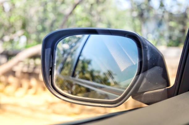 istock Natural view from car window and side view of black car in wing mirror while driving for transportation concept 1295266070