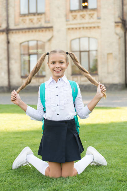 istock I never learn. Carefree student. Smiling pupil sit on grass. Have fun. Happy kid relaxing outdoors. Cheerful schoolgirl. Schoolgirl relaxing. Happy childhood concept. International childrens day 1295266816