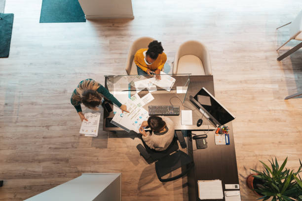 istock Women at work in the office looking at charts on a screen 1295268440