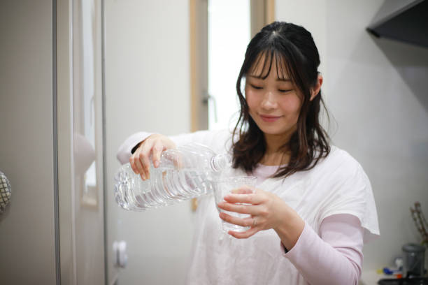 istock Woman drinking water 1295269116
