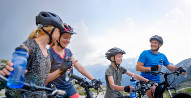 istock Family taking break during mountain biking 1295269888