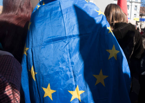 istock EU citizens with blue European Union flag 1295270206