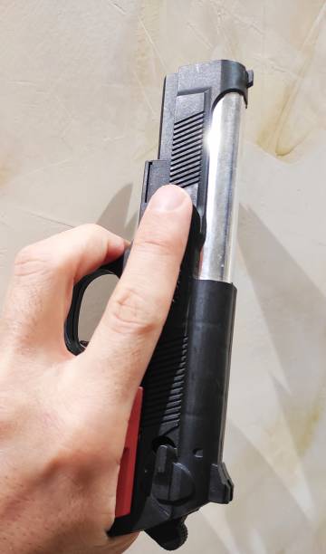 istock Man holding the gun 1295270673