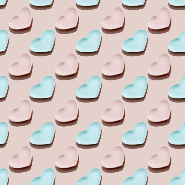 istock Heart shaped blue and pink empty plates on pink background. Seamless pattern. Happy Valentine's Day. 1295272209