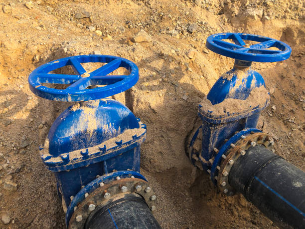 istock Valves on pipeline in ground. Pipe valves in trench 1295274529