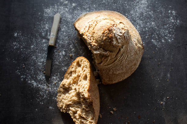 istock Homemade bread close up photo on dark background. 1295276576