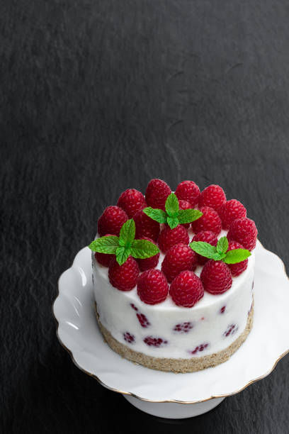 istock No sugar cheese cake made with yoghurt and berry on black stone background 1295280145