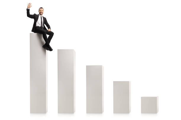 istock Businessman sitting on the highest column in a bar chart and waving 1295282211