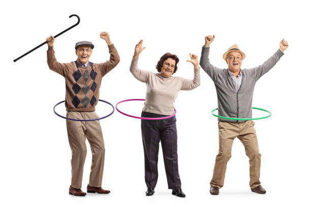 personas mayores felices girando hula hoops - hooping fotografías e imágenes de stock