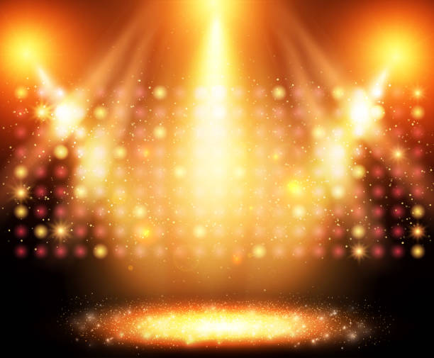 istock Shining abstract background with golden glow spotlights and dust 1295283777