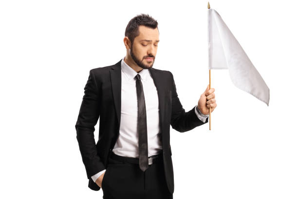 istock Sad professional man in a suit holding a white flag 1295283796