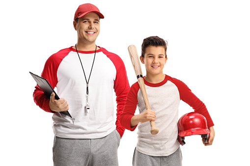 Baseball coach and a boy with a bat smiling at camera isolated on white background
