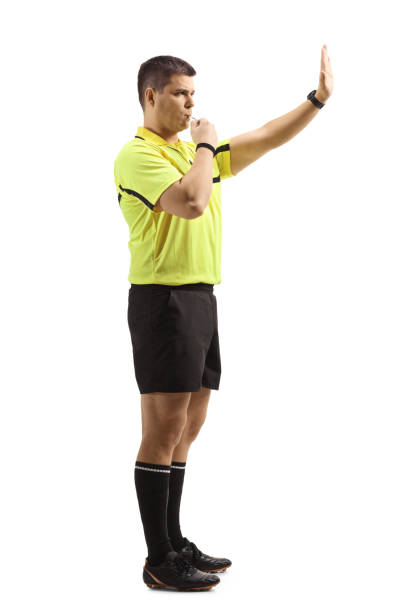 istock Football referee blowing a whistle and gesturing stop with hand 1295285932