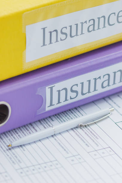 istock Clean insurance form, colored folders and a pen 1295287939