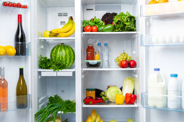 istock Open fridge full of fruits, vegetables and drinks 1295287992