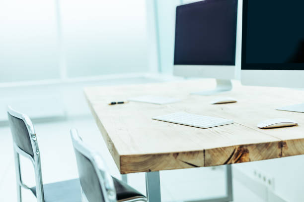 istock background image of personal computers on the office Desk 1295288157