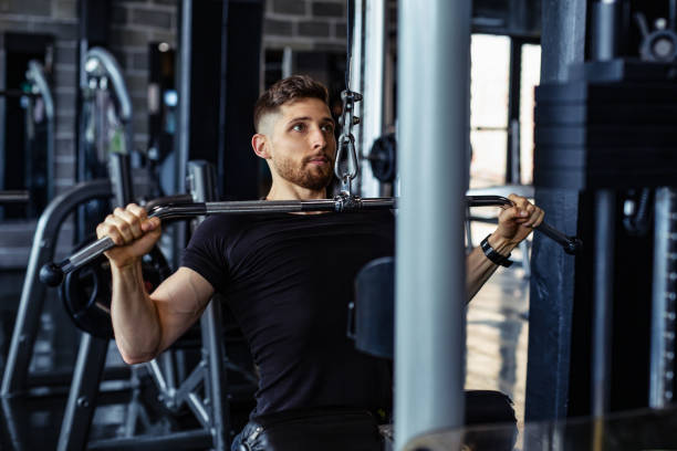 istock Young handsome strong man doing exercises in gym 1295288452