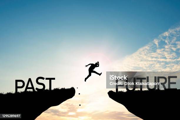 Go Ahead And Continuously Improvement Concept Silhouette Man Jump On A Cliff From Past To Future With Cloud Sky Background Stock Photo - Download Image Now