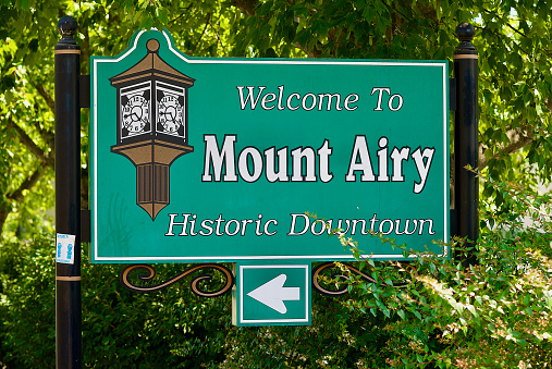 Mount Airy, North Carolina / USA - July 5, 2020: Close-up of a “Welcome To Mount Airy Historic Downtown” sign near historic downtown Mount Airy, a popular tourist town.