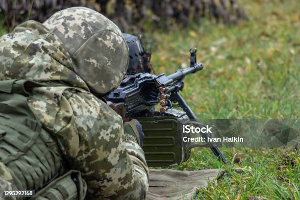 Machine Gunner Operator In Camouflage Uniform And Body Armor Shoots ...