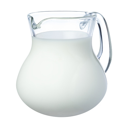 Fresh milk in a glass jug isolated on white background