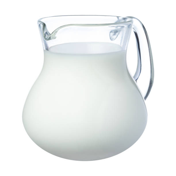 Fresh milk in a glass jug isolated on white Fresh milk in a glass jug isolated on white background jar of milk stock pictures, royalty-free photos & images