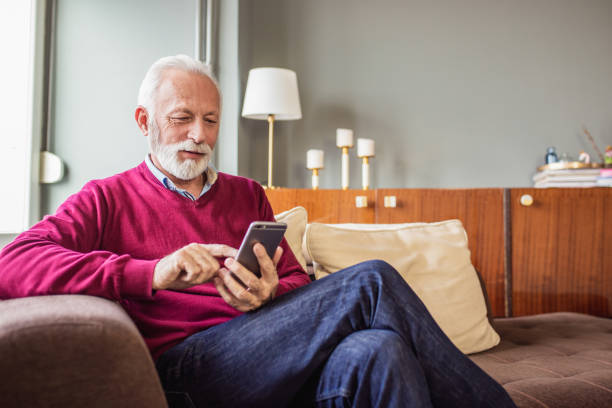 istock A portrait of a senior man using mobile phone at home 1295294256
