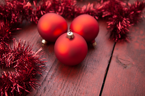 Christmas decorations - three matt red baubles with red tinsel