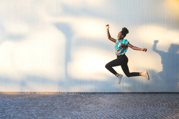 istock Happy woman jumping 1295294439