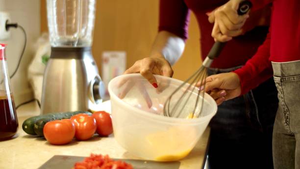 istock Two women are cooking in a kitchen 1295295391
