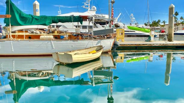 istock reflective boats in the harbor 1295295911