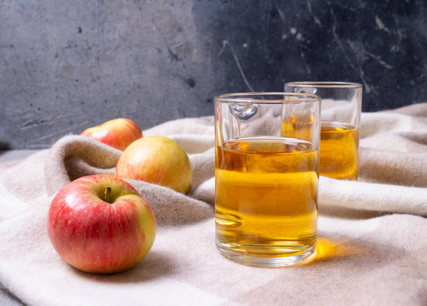 istock Glass mugs with apple juice and apples. 1295296340